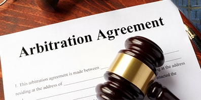 Arbitration and Mediation Practice Area represented by gavel over Arbitration Agreement papers